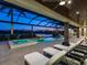 Stunning outdoor living space with a pool, spa, and fire features with beautiful sunset lake views at 18826 Ganton Ave, Lakewood Ranch, FL 34202