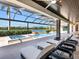 Luxury outdoor lounge with a pool, spa, and fire features, perfect for relaxing and entertaining lakeside at 18826 Ganton Ave, Lakewood Ranch, FL 34202