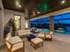 Serene outdoor space with comfortable seating around a pool, spa, and fire features with lake views at 18826 Ganton Ave, Lakewood Ranch, FL 34202