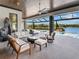 Serene outdoor space with comfortable seating, overlooking a pool and lake, perfect for relaxation and entertaining at 18826 Ganton Ave, Lakewood Ranch, FL 34202