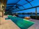 Expansive pool area featuring modern design elements, colorful lighting, and a stunning waterfront view at 18826 Ganton Ave, Lakewood Ranch, FL 34202