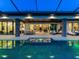 Elegant outdoor living area with a modern pool reflecting the home's luxurious interior and open design at 18826 Ganton Ave, Lakewood Ranch, FL 34202
