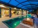 Stunning outdoor space with a sleek pool, fire features, and an open-concept layout to the home's interior at 18826 Ganton Ave, Lakewood Ranch, FL 34202