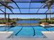 Beautiful pool featuring a serene lake view and decorative fire features for ultimate outdoor enjoyment at 18826 Ganton Ave, Lakewood Ranch, FL 34202