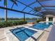 Inviting screened pool and spa overlooking a tranquil lake, perfect for relaxation and enjoying the view at 18826 Ganton Ave, Lakewood Ranch, FL 34202