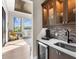 Stylish wet bar featuring custom cabinetry, a wine fridge, and backyard views at 18826 Ganton Ave, Lakewood Ranch, FL 34202