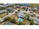 Aerial view of a home with a pool, landscaping, and a nice neighborhood near a pond at 2647 Britannia Rd, Sarasota, FL 34231