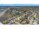 This aerial captures a home with a pool in a peaceful residential neighborhood close to local amenities and ocean views at 2647 Britannia Rd, Sarasota, FL 34231