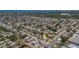 Aerial view of a residential community with mature trees and lush greenery near lakes and the ocean at 2647 Britannia Rd, Sarasota, FL 34231