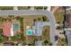 Aerial view showcases a property with a backyard pool and patio in a lovely neighborhood setting at 2647 Britannia Rd, Sarasota, FL 34231