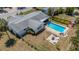 Aerial view of a backyard featuring a pool, fire pit area, and well-maintained landscaping at 2647 Britannia Rd, Sarasota, FL 34231