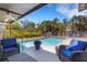 Sparkling swimming pool with outdoor lounge chairs, lush landscaping, and a fenced-in yard at 2647 Britannia Rd, Sarasota, FL 34231