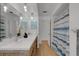 Modern bathroom with double sinks, wooden cabinets, stylish lighting, and a shower with blue curtain at 2647 Britannia Rd, Sarasota, FL 34231