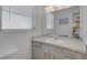 Bright bathroom featuring a single sink, light cabinets, and a large mirror at 2647 Britannia Rd, Sarasota, FL 34231