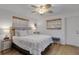 Comfortable bedroom with a ceiling fan, two windows, a bed and a side table at 2647 Britannia Rd, Sarasota, FL 34231