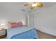 A bedroom with hardwood floors, ceiling fan, and a closet can be seen in this image at 2647 Britannia Rd, Sarasota, FL 34231