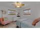 Bright bedroom features wood floors, a ceiling fan, and two windows with wood blinds at 2647 Britannia Rd, Sarasota, FL 34231