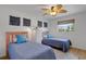 Bright bedroom with hardwood floors, ceiling fan, and two twin beds with matching quilts at 2647 Britannia Rd, Sarasota, FL 34231