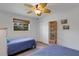 Bedroom features wood floors, a ceiling fan, twin beds with quilts, and a window at 2647 Britannia Rd, Sarasota, FL 34231