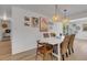 Dining room with a white table, woven chairs, and decoratively adorned walls at 2647 Britannia Rd, Sarasota, FL 34231