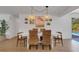 Bright dining room featuring modern lighting and seamless access to the outdoor pool area at 2647 Britannia Rd, Sarasota, FL 34231