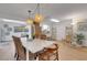 Open concept dining room with modern lighting and plenty of natural light at 2647 Britannia Rd, Sarasota, FL 34231