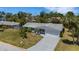 Beautiful single-story house showcases a lush front yard, palm trees, and a spacious driveway at 2647 Britannia Rd, Sarasota, FL 34231