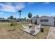 Cozy backyard fire pit area with four Adirondack chairs, perfect for outdoor entertaining and relaxation at 2647 Britannia Rd, Sarasota, FL 34231