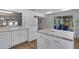 Bright kitchen featuring white cabinets, a center island with countertop, and stainless steel appliances at 2647 Britannia Rd, Sarasota, FL 34231
