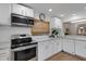 Bright kitchen featuring stainless steel appliances and white cabinetry at 2647 Britannia Rd, Sarasota, FL 34231