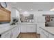 Open concept kitchen with white cabinetry and stainless steel appliances at 2647 Britannia Rd, Sarasota, FL 34231
