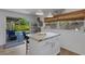 Bright kitchen featuring a center island with countertop and sliding glass doors to the backyard at 2647 Britannia Rd, Sarasota, FL 34231