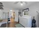 This is a laundry room featuring a washer and dryer, shelves, and access to another room at 2647 Britannia Rd, Sarasota, FL 34231