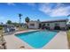 Backyard with a private swimming pool, surrounded by a patio and manicured landscaping at 2647 Britannia Rd, Sarasota, FL 34231