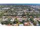 Wide aerial shot of a neighborhood with mature trees, well-maintained lawns, and houses with pools at 2908 Mayflower St, Sarasota, FL 34231
