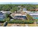 Aerial view of a home with a screened-in pool, lush landscaping, and a fenced backyard at 2908 Mayflower St, Sarasota, FL 34231