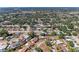 Extensive aerial view of a community, featuring well-spaced homes, mature trees, and clear blue skies above at 2908 Mayflower St, Sarasota, FL 34231