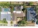 Aerial view of a property featuring a screened-in pool, backyard firepit, and manicured landscaping in a residential neighborhood at 2908 Mayflower St, Sarasota, FL 34231