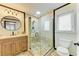 Bright bathroom with tiled glass shower, vanity, and tiled floor offers a spa-like experience at 2908 Mayflower St, Sarasota, FL 34231