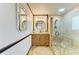 Elegant bathroom featuring glass enclosed shower, vanity and decorative mirror with tiled floor at 2908 Mayflower St, Sarasota, FL 34231