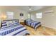 Cozy bedroom features two twin beds with blue and white striped bedding and nautical themed pillows and decor at 2908 Mayflower St, Sarasota, FL 34231