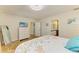 Bedroom with tiled floors includes a dresser and TV with access to additional rooms at 2908 Mayflower St, Sarasota, FL 34231