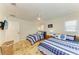 Bedroom with two beds, ceiling fan, bedside table, and a tile floor at 2908 Mayflower St, Sarasota, FL 34231