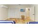 Bedroom with tiled floor has a large closet and television mounted on the wall for entertainment at 2908 Mayflower St, Sarasota, FL 34231