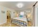 Bedroom featuring tile flooring, coastal-themed decor, and an ensuite bathroom, creating a tranquil retreat at 2908 Mayflower St, Sarasota, FL 34231