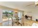 Bright dining room with a glass table, sliding doors to the screened-in pool, and a comfortable workspace at 2908 Mayflower St, Sarasota, FL 34231