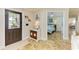 Stylish entryway with tile floors, decorative furniture, and a view into a cozy bedroom with a calming color palette at 2908 Mayflower St, Sarasota, FL 34231