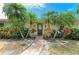 Attractive front entrance featuring a brick walkway, tropical plants, and a welcoming front door at 2908 Mayflower St, Sarasota, FL 34231