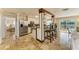 Open kitchen featuring stainless steel appliances, a breakfast bar, and views of the living area and backyard at 2908 Mayflower St, Sarasota, FL 34231