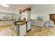 Open kitchen with breakfast bar, stainless steel appliances and seamlessly connected to living area, ideal for entertaining at 2908 Mayflower St, Sarasota, FL 34231
